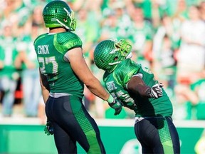Tearrius George #93 of the Saskatchewan Roughriders celebrates a sack in a game between the Ottawa Redblacks and Saskatchewan Roughriders in week 13 of the 2014 CFL season at Mosaic Stadium on September 21, 2014 in Regina.