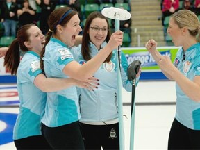 Third Lori Olson-Johns, right, gets ready to join the team celebration with, from left, second Dana Ferguson, lead Rachelle Brown and skip Val Sweeting after winning the Canada Cup women’s final on Dec. 7, 2014, at Encana Arena in Camrose, Alta.