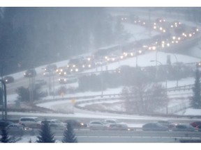 Traffic moves slowly through the river valley during the falling snow in Edmonton on Nov. 27, 2014.