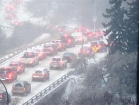 Traffic slowly snakes its way through the river valley in the falling snow and frigid temperatures of Nov. 27, 2014.