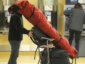 A traveler at Edmonton International Airport. The airport is projecting 25,000 passengers a day over the next two weeks.