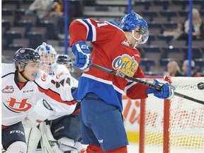 Tyler Robertson of the Edmonton Oil Kings, attempts to bat the flying puck past goalie Stuart Skinner of the Lethbridge Hurricanes at Rexall Place in Edmonton.