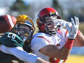 University of Alberta Golden Bears’ Kael Schryver, left, battles University of Calgary Dinos receiver Brett Blaszko, who can’t make the catch during football action at Foote Field on Saturday, Oct. 18, 2014.