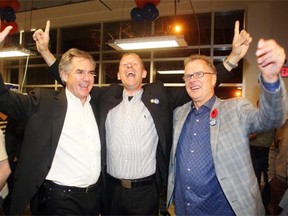 Victorious Tories, from left, Premier Jim Prentice, Mike Ellis and Gordon Dirks celebrate after winning their ridings, Calgary-Foothills, Calgary-Elbow and Calgary West in the by-elections Monday night October 27, 2014.