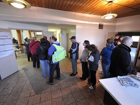 People line up bright and early to vote in the Alberta provincial election at a Ritchie polling station in Edmonton on Monday, April 23, 2012.
