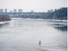 Warren Currie stand up paddles the North Saskatchewan River near the Groat Bridge on possibly the last day of open water as cold weather closes in for the weekend in Edmonton on, Tuesday, Nov. 25, 2014.