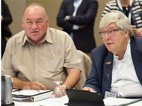 Yukon Premier Bob McLeod, left, and Alberta Premier Dave Hancock attend a session at the annual Council of the Federation meeting in Charlottetown on Friday, August 29, 2014.