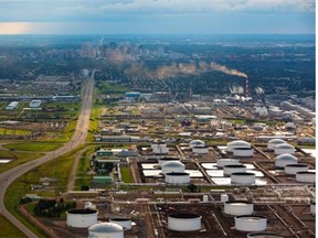 An aerial view of the Imperial Oil Strathcona refinery with the Kinder Morgan and Enbridge oil terminals in the foreground and the Edmonton skyline in the background.
