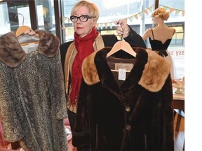 Angela Larson, owner of Swish Vintage store, shows her vintage furs in Edmonton.