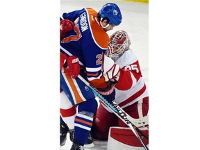 Boyd Gordon (27) crashes into Jimmy Howard (35) as the Edmonton Oilers play the Detroit Red Wings at Rexall place in Edmonton, January 6, 2015.