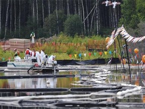 Canadian Natural Resources Limited (CNRL) workers cleaning up the bitumen emulsion on this marsh after it seeped up through a fissure under the water at their Primrose oilsand projects north of Cold Lake, August 8, 2013. A total of four sites have this seepage occurring and to date 7300 barrels have been collected from 13.5 hectares.