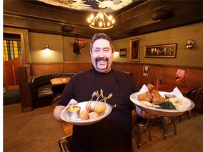 Chael MacDonald, consulting chef at the Denizen Hall, shows off a few of the specialties on the menu: the fried chicken and mini-corn dogs.