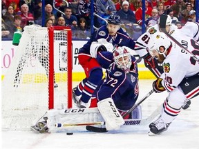 Columbus Blue Jackets netminder Sergei Bobrovsky stops a shot by Brandon Saad of the Chicago Blackhawks during a National Hockey League game at Nationwide Arena in Columbus, Ohio, on Dec. 20, 2014.