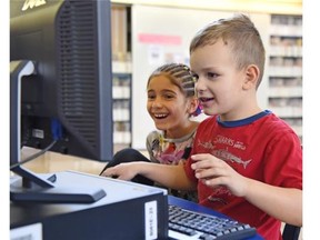 Cooper Moisey and Lidia Jamela, 6, play video game Minecraft at school with Grade 1 teacher Breanne Lowe at Good Shepherd Catholic school on Jan. 14, 2015. Lowe uses the popular video game to teach in a way that is motivating and fun.