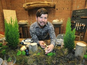 Cory Christopher at his studio with his moss-filled centrepiece