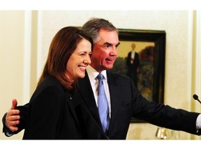 Danielle Smith and Premier Jim Prentice speak at a news conference at Government House in Edmonton on Wednesday, Dec. 17, 2014. Smith and Prentice announced that nine Wildrose caucus members, including Smith, were uniting with the Progressive Conservative caucus.