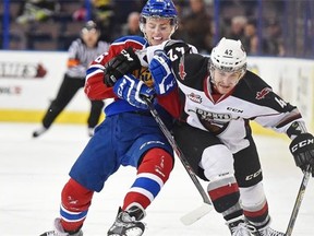 Davis Koch of the Edmonton Oil Kings tries to slow down Carter Popoff of the Vancouver Giants during a Western Hockey League game at Rexall Place on Nov. 27, 2014.