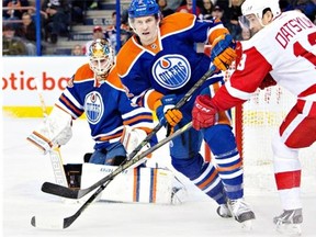 Detroit Red Wings Pavel Datsyuk (13) and Edmonton Oilers Jeff Petry (2) battle during NHL action in Edmonton on January 6, 2015.