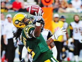 Edmonton Eskimos slotback Fred Stamps couldn’t hang on to this pass while being hauled down by Hamilton Tiger-Cats defensive back Craig Butler during a Canadian Football League game at Commonwealth Stadium on July 4, 2014.