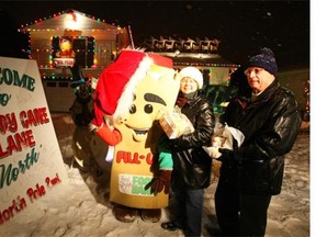 Edmonton’s Food Bank mascot “Fill Up,” Majorie Bencz, executive director of the food bank, and Jack Little, food bank chair, join in officially opening Candy Cane Lane in 2008.