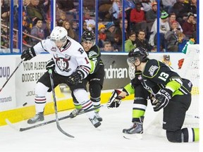 Edmonton Oil Kings Ashton Sautnerk, left, and Brandon Baddock put pressure on Red Deer Rebels Riley Sheen during second period WHL action at Rexall Place on Dec. 27, 2014.