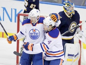Edmonton Oilers’ Benoit Pouliot (67) is congratulated by teammate Taylor Hall (4) after he scored a goal, as St. Louis Blues goalie Jake Allen (34) regroups, in the third period of a NHL hockey game, Tuesday, Jan. 13, 2015 in St. Louis. The Blues beat the Oilers 4-2.