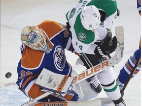 Edmonton Oilers goalie Ben Scrivens is hit by Dallas Stars centre Jamie Benn during NHL action on Dec. 21, 2014, in Edmonton.