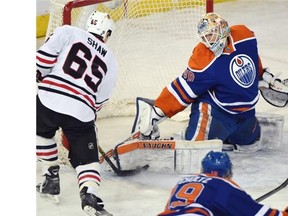 Edmonton Oilers goalie Ben Scrivens (30) makes a great save on Andrew Shaw (65) of the Chicago Blackhawks at Rexall place in Edmonton, January 9, 2015.