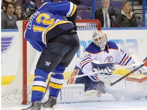 Edmonton Oilers goalie Ben Scrivens stops a shot from St. Louis Blues forward Jori Lehtera during Friday’s National Hockey League game at the Scottrade Center in St. Louis.