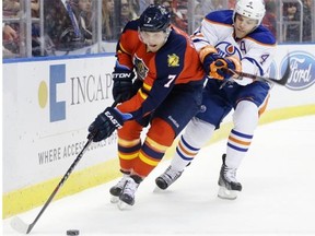 Edmonton Oilers left-winger Taylor Hall takes a whack with his stick at Florida Panthers defenceman during a National Hockey League game at Sunrise, Fla., on Jan. 17, 2015.