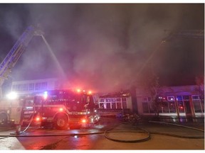 Firefighters battle an early morning fire in the historic Roxy Theatre on 124th St.-107 Av in Edmonton on Tuesday Jan. 13, 2015.