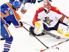 Florida Panthers goalie Roberto Luongo (1) makes the save on Edmonton Oilers Jeff Petry (2) during third period NHL hockey action in Edmonton on Jan. 11, 2015.