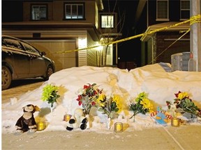 Flowers, candles and stuffed animals were placed in front of an Edmonton home where seven bodies were discovered on December 30, 2014. The deceased were victims of a murder-suicide that took nine lives in all.