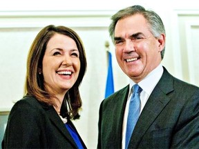 Former Wildrose Leader Danielle Smith and Premier Jim Prentice address the media after a caucus meeting Wednesday in Edmonton. Smith and nine other Wildrose MLAs crossed the floor to sit as members of the PC caucus.