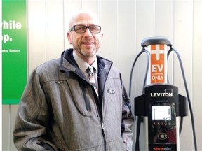 Gary Hill of Koch Ford Lincoln demonstrates Southgate’s charging station.