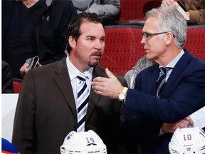 General Manager Craig MacTavish, right, talks with interim coach Todd Nelson on the bench during the first period of the NHL game against the Arizona Coyotes at Gila River Arena on December 16, 2014 in Glendale, Arizona.