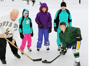 Hockey coach Bob de la Salle (left) -- shown here at Victoria Park with his grandchildren -- has written a guide about teaching young children how to play hockey. His grandchildren, from left, are Chantal Cohen, Erin de la Salle, Julie Cohen and Lucas de la Salle.