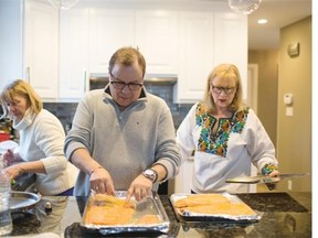 Irene Miskiw, left, Yuriy Andryjowycz, centre, and Olesia Luciw-Andryjowycz, prepare their Ukrainian Christmas Eve meal in their Edmonton home on Jan 6, 2015.