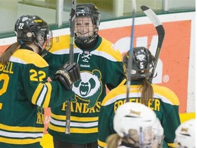 Jessica Kampjes (95) of the University of Alberta Pandas celebrates with teammates Alison Campbell (22) and Janelle Froehler (5) after scoring the second goal of Friday’s Canada West women’s hockey game against the Lethbridge Pronghorns at Clare Drake Arena.