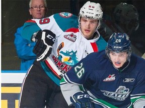 Kelowna Rockets centre Leon Draisaitl checks Seattle Thunderbirds winger Nolan Volcan during WHL action on Jan. 16, 2015, at Prospera Place in Kelowna, B.C.