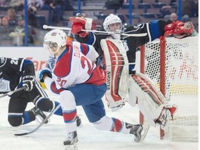 Mads Eller of the Edmonton Oil Kings sends Victoria Royals goalie Justin Paulic flying during a Western Hockey League game at Rexall Place on Sunday.