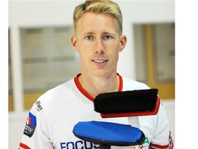 Marc Kennedy of Kevin Koe’s new dream team displays the two most common types of curling brooms — a hair brush (top) and a synthetic head.