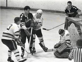 Monarchs’ backup goalie, Barry Richardson, stopped Miners’ bid for goal with help of Bob Solinger (2) and Gary Young in January, 1969.