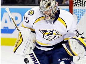 Nashville Predators goalie Pekka Rinne blocks a shot from the San Jose Sharks during the third period of an NHL hockey game Saturday, Dec. 13, 2014, in San Jose, Calif.