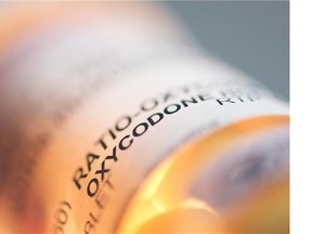 Prescription pill bottle containing oxycodone and acetaminophen are shown in this June 20, 2012 photo.