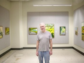 Jeff Collins stands amongst some of his art put on display at Enterprise Square on Dec. 20, 2014.