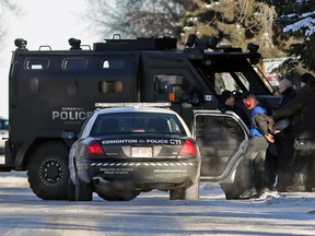 A man is arrested at a weapons incident in a residential neighborhood near 106th Street and 53rd Avenue in south Edmonton on Jan. 8, 2015.