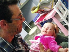 Paul Jean holds his daughter, Dani Isabella Jean, shortly before she died on May 4, 2013. She was found tangled in her foster mother's bed sheets.