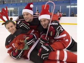 Team Canada's Josh Morrissey, left to right, Max Domi and Frederik Gauthier ham it up during a photo shoot in Toronto on Saturday, December 20, 2014.