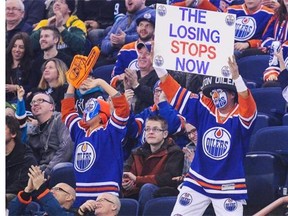 Oilers fans cheer on the team in a December game at Rexall Place. The team had essentially played its way out of the playoffs by November, just 20 or so games in to the 82-game season.